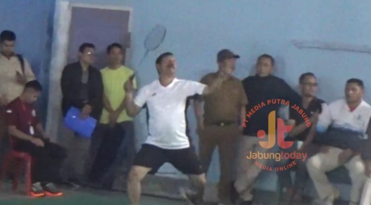 Bupati Kerinci, Monadi, melakukan smash dalam laga ekshibisi pembuka Turnamen Bulutangkis Bupati Cup II 2025 di Gedung Serbaguna Desa Dusun Baru, Kecamatan Siulak, Selasa (5/8). (Dok. Yola)