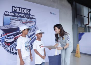 Petugas Jasa Raharja menyerahkan bingkisan kepada anak-anak peserta kegiatan sosial dengan latar belakang kampanye “Mudik Aman Sampai Tujuan”, (Dok. Humas JR Jambi)