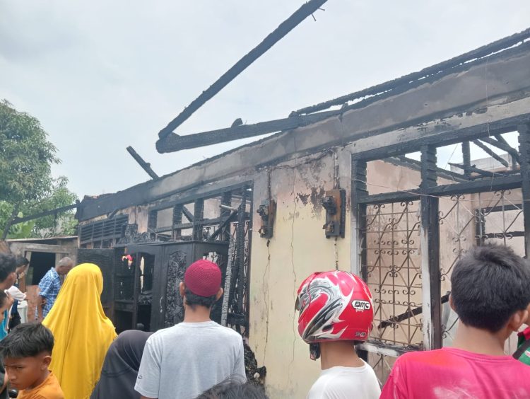Warga berupaya membantu membersihkan puing-puing kebakaran yang menghanguskan satu rumah beserta tiga bedeng di RT 09 Kelurahan Solok Sipin, Kota Jambi, Selasa (27/9/2025). (Dok. Rio)