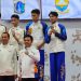 Atlet wushu Jambi Candika dan Maulana Ahmad (kanan) menerima medali emas usai tampil di nomor dullian putra pada PON Bela Diri 2025 di GOR Djarum Kaliputu, Kudus, Jawa Tengah, Minggu (26/10/2025). (Dok, Koni Jambi)